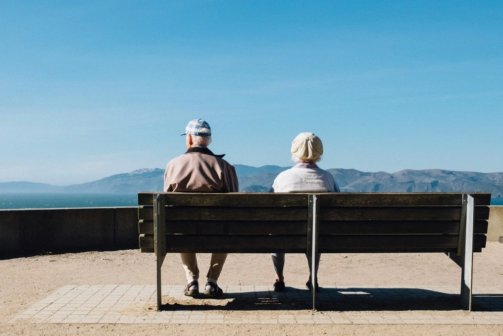 Elderly couple enjoying the seaside together.