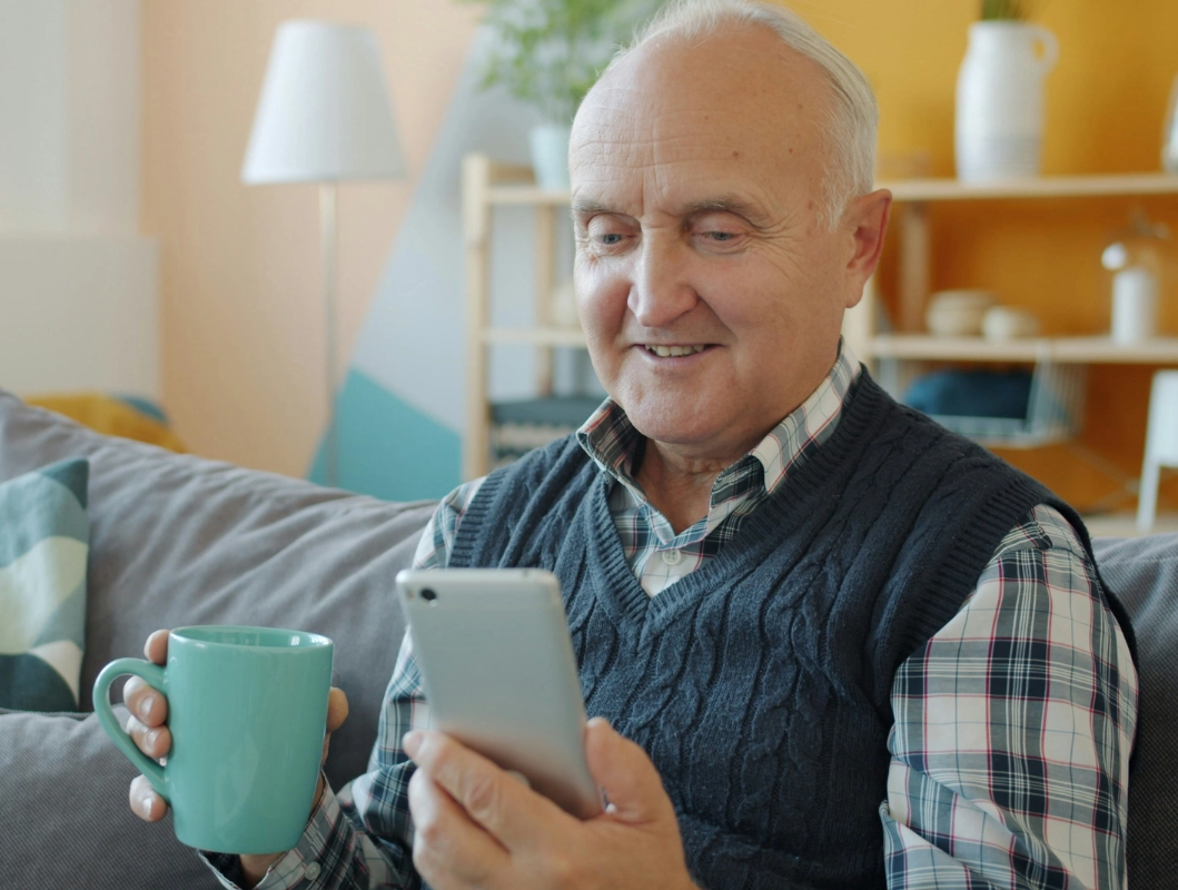 Happy elderly man on his phone